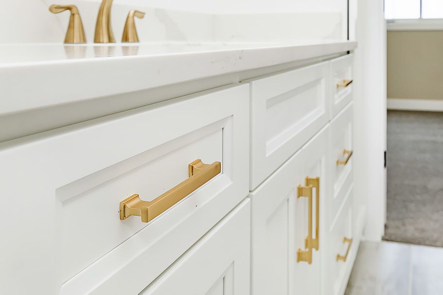 Close Up of Gold Handles on Bathroom Cabinets