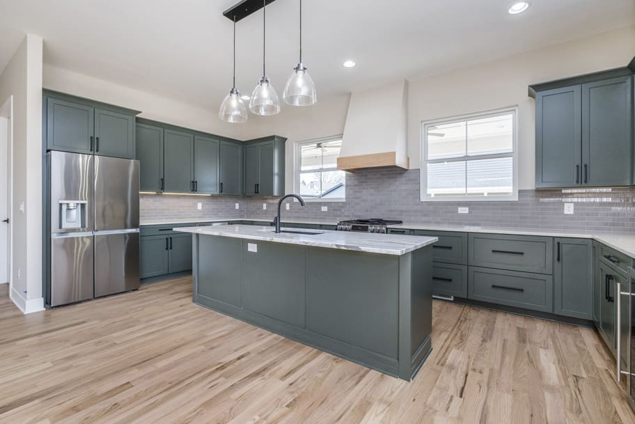 Green Kitchen Cabinets with Gray Backsplash