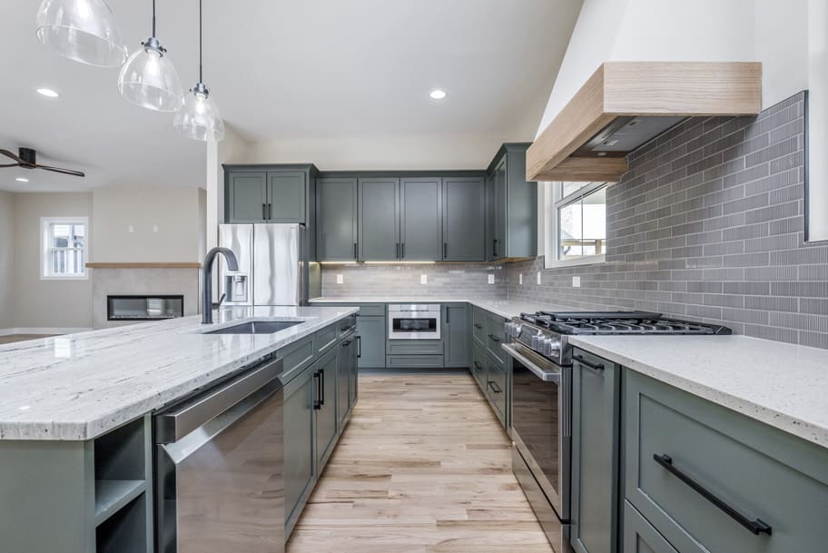 Modern Kitchen with Custom Green Cabinets and Stainless Steel Appliances