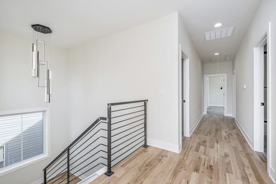 Upstairs Landing with Modern Light and Stair Railing
