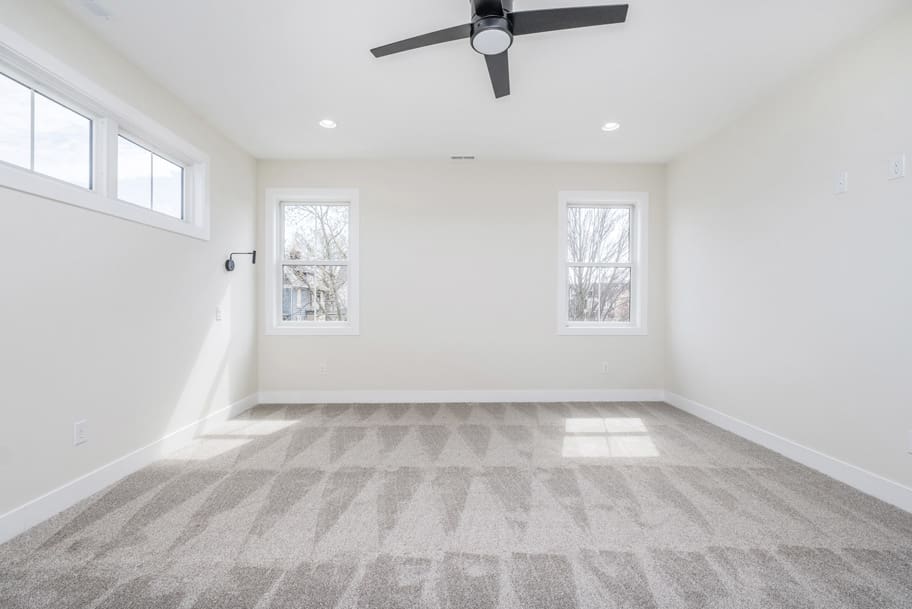 Primary Bedroom with Carpet and Light From Windows