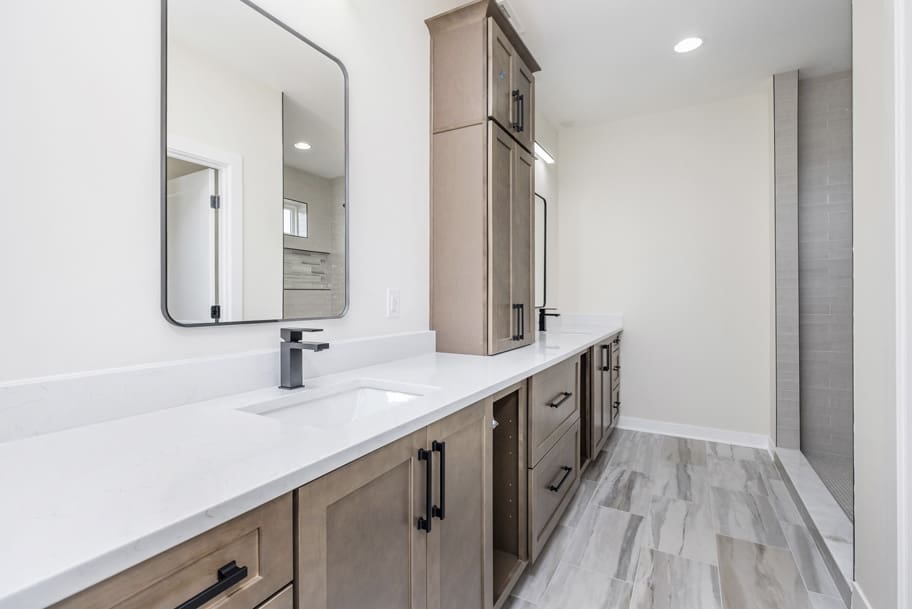 A Bathroom With A Spacious Vanity and Walk-in Shower