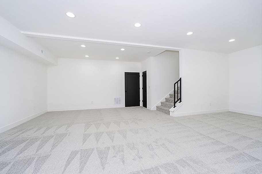 Finished Basement with Stairs, Carpet, Recessed Lighting, and Black Doors