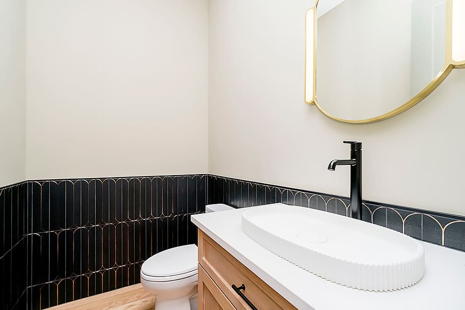 Powder Room with Black Patterned Tile Accent Wall in a Custom New Construction Home by Gem Homes Indianapolis