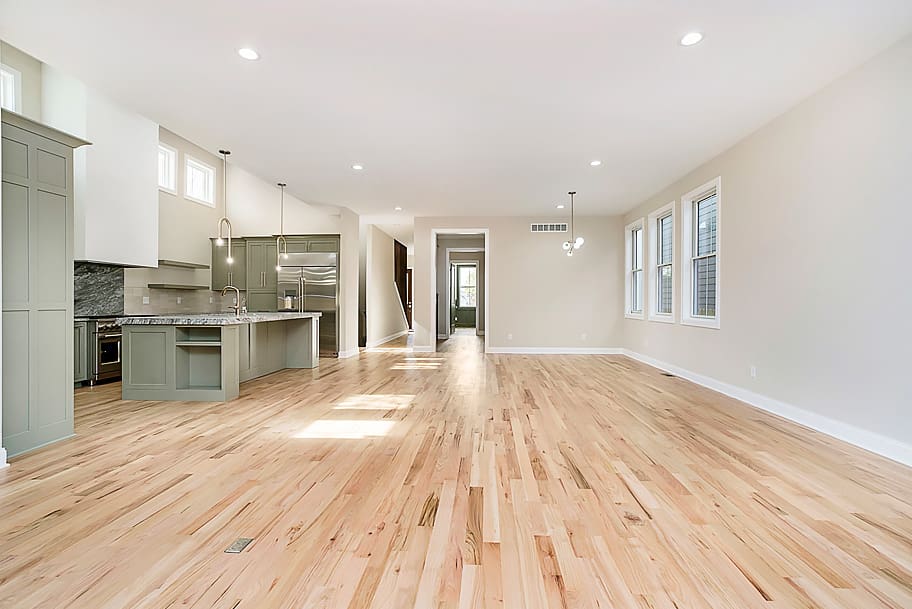 Open Concept Living Room with Light Wood Floors and Modern Lighting in a Custom Home by Gem Homes Indianapolis