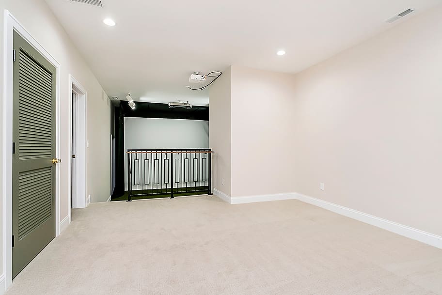 Basement Area Leading into Custom Golf Simulator Room in a Luxury Home by Gem Homes Indianapolis