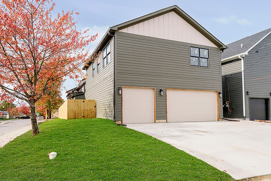 Exterior of Green Detached Garage with Two White Garage Doors in a Custom Home by Gem Homes Indianapolis