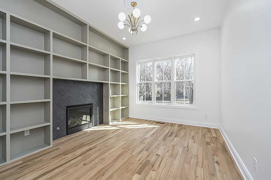 Library Room with Green Built-In Shelving and Fireplace in a Custom Home by Gem Homes Indianapolis