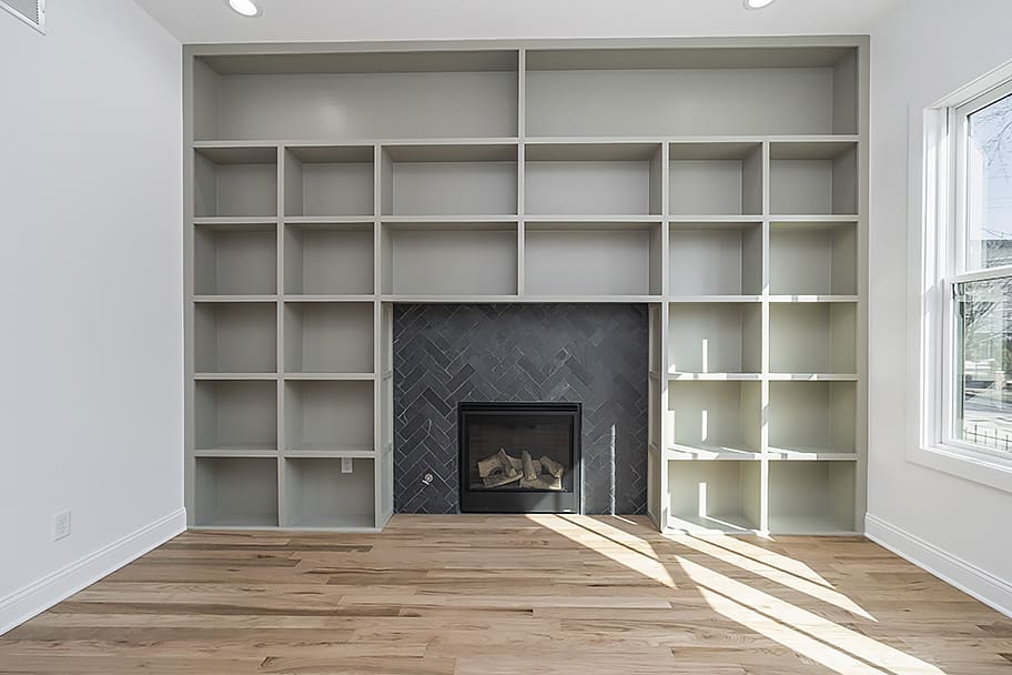 Library Room with Green Built-In Shelving and Fireplace in a Custom Home by Gem Homes Indianapolis