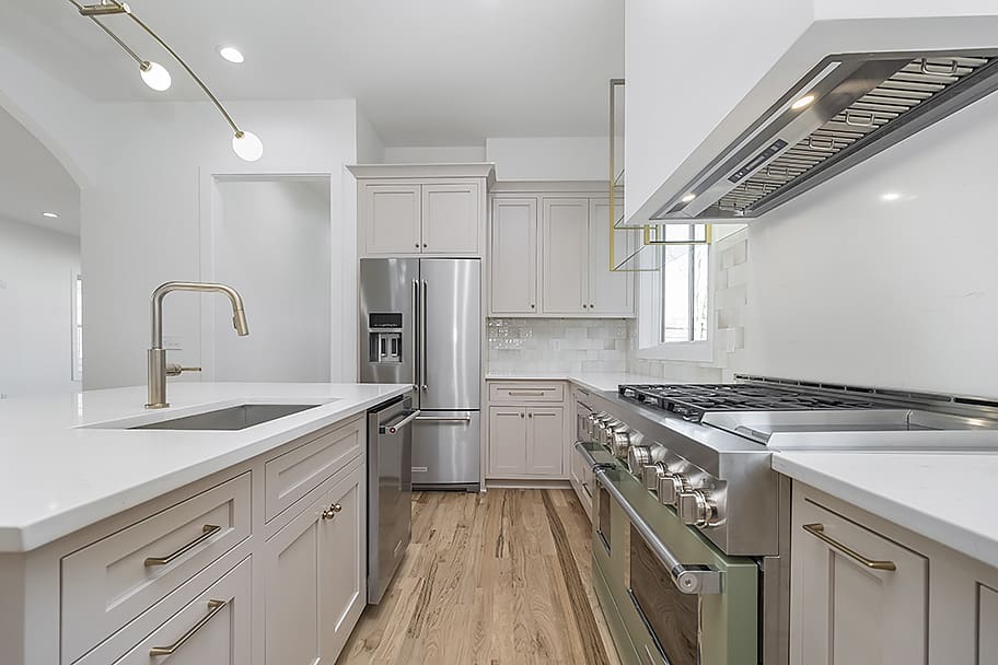 Close-Up of Beige-Pink Kitchen with Glossy Beige Square Backsplash and Gold Accents in a Custom Home by Gem Homes Indianapolis