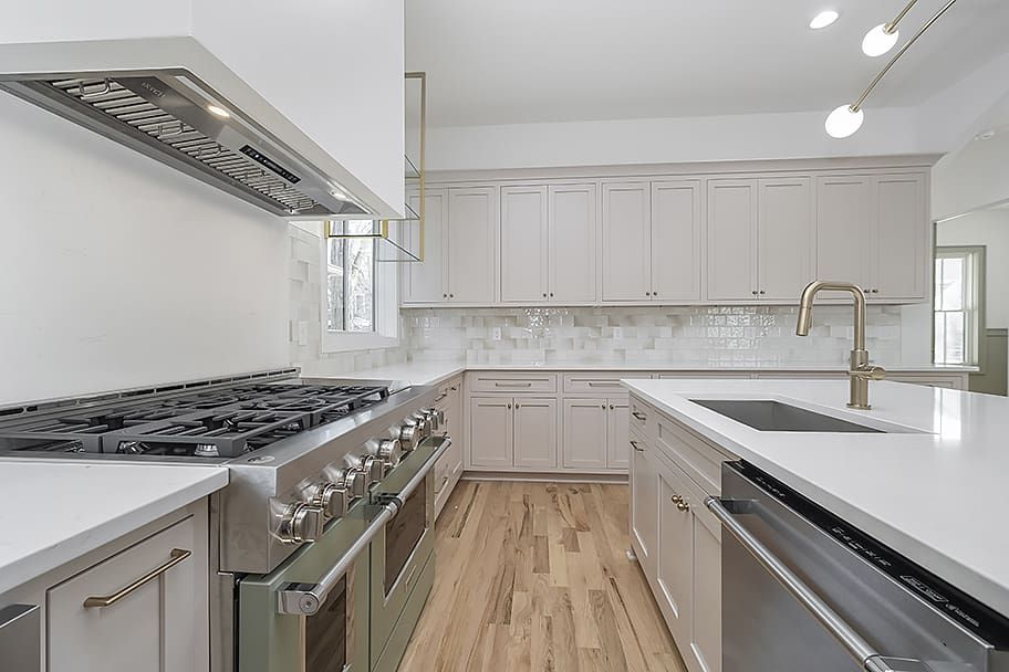 Kitchen with Ample Counter Space, Glossy Beige Square Backsplash, and Gold Accents in a Custom Home by Gem Homes Indianapolis
