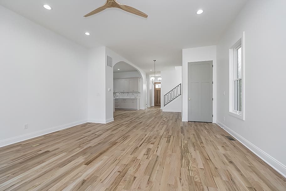 Living Room with Wooden Fan and Archway Leading into Kitchen in a Custom Home by Gem Homes Indianapolis