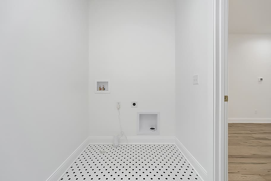 Laundry Room with White and Black Circle Tile in a Custom Home by Gem Homes Indianapolis