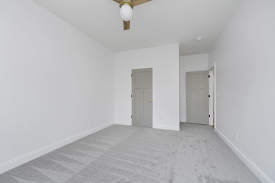 Guest Bedroom with Carpet and Olive Green Doors in Home by Gem Homes Indianapolis