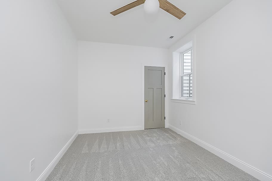 Bedroom with Green Closet and Wooden Fan